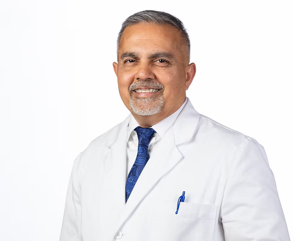 Dr. Zaheer Shah wearing his physician&rsquo;s white coat